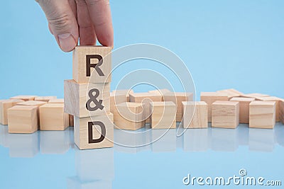 hand holding wood cube block with R and D text. financial, management, economic, business concept Stock Photo