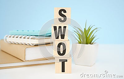 wooden cube with swot text. Strength Weakness Opportunity Threat Stock Photo