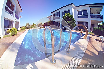 Hand rails of swimming pool extra wide angle fishe-eye lens toned Stock Photo