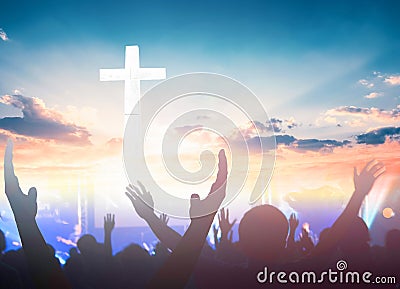Worship and praise concept: christian people hand rising on sunset background Stock Photo