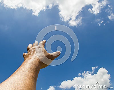 Hand reaching out towards the sky Stock Photo