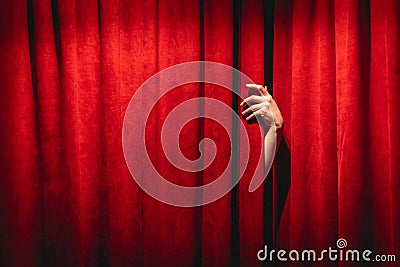 The hand on the red curtain background. The Twin peaks black lodge concept Stock Photo