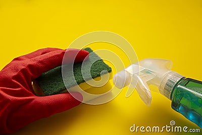 Hand in red rubber glove with a sponge and liquid detergent Stock Photo