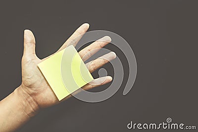 Hand with reminder sticky note empty space for text Stock Photo