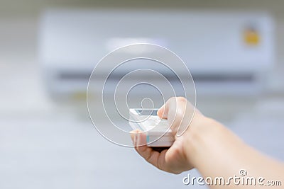 Hand remote control Turning the air conditioner Stock Photo