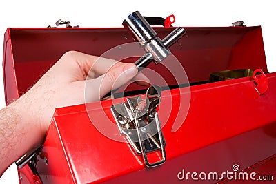 Hand removing a wrench from a toolbox Stock Photo