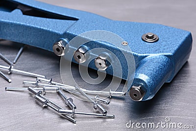 Hand rivet tool on metal surface Stock Photo