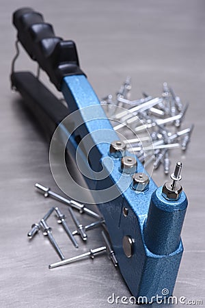 Hand rivet tool on metal surface Stock Photo