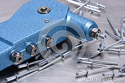 Hand rivet tool on metal surface Stock Photo