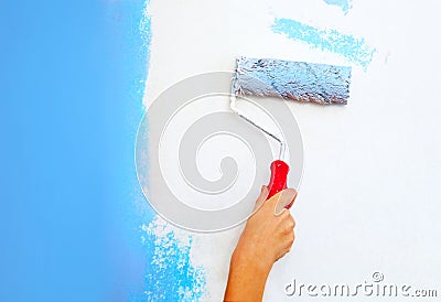 Hand with roller brush painting Stock Photo