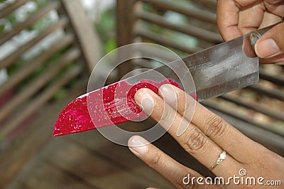 Woman left hand with ring, rubbing knife Stock Photo