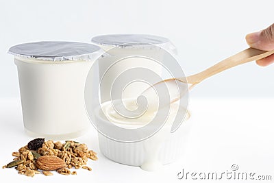 Hand`s woman holding wooden spoon with healthy flavored yogurt i Stock Photo