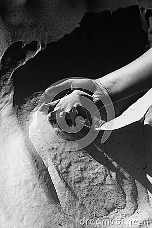 Hand in the sand black and white Stock Photo