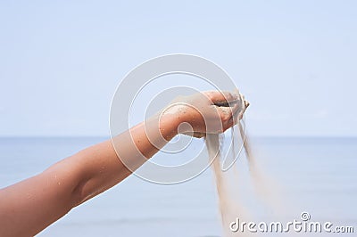 Hand with sand on sea Stock Photo