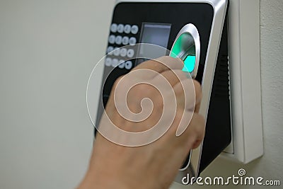 hand scanning finger print on access control machine. hour work Stock Photo