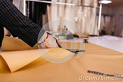 Hand scissor fabric. Cutting fabric closeup. Tailor at work Stock Photo
