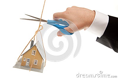 Hand with Scissors Cutting String Holding House Stock Photo