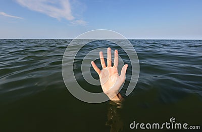 hand on the sea of a person who is drowning and seeks help Stock Photo