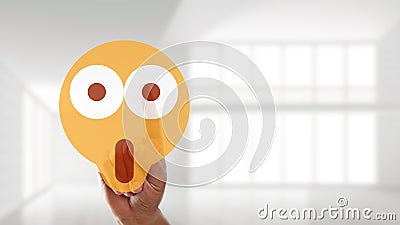 Hand is selecting a surprised mood emoticon Stock Photo