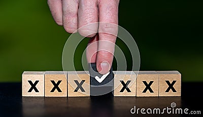 Hand selects a black cube. Symbol for making an decision Stock Photo