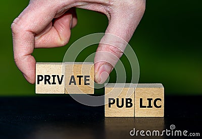 Hand selects cubes with the word private instead of cubes with the word public. Stock Photo