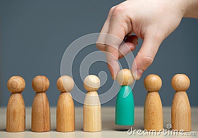 The hand selects a person from a business team. The concept of finding people and workers on the job. Management of team, the Stock Photo