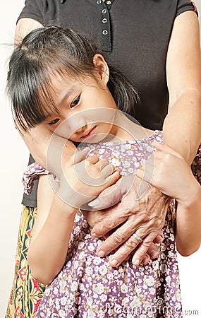 Hand of senior hugging with her child. Asian llttle girl embrace Stock Photo