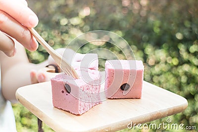 Hand on serving Thai steamed cotton cake Stock Photo