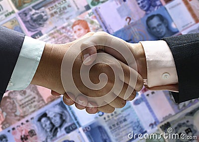 Hand shake background foreign currency Stock Photo