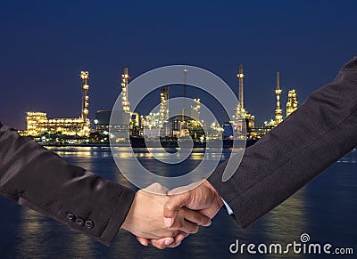 Hand shake between a businessman on Petrochemical factory background Stock Photo