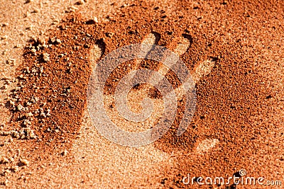 Hand shape on sand like aboriginal art style Stock Photo