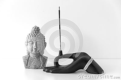 Hand shaped incensory and Buddha figured candle Stock Photo