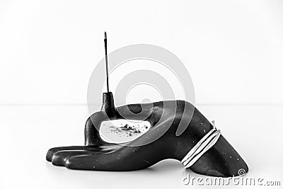 Hand shaped incensory and incense Stock Photo