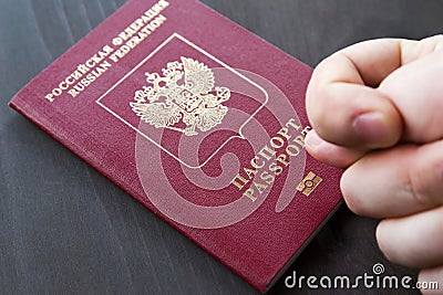 Hand showing the fig sign, on red passport background Stock Photo