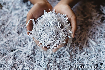 Hand showing heap of shredded paper. Stock Photo