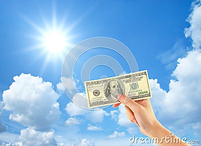 Hand showing money over sky Stock Photo