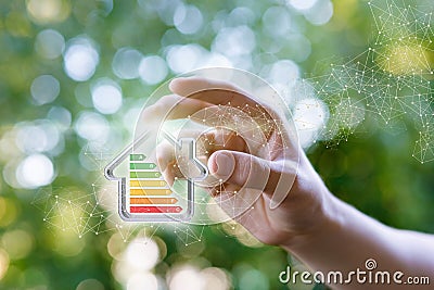 Hand shows a model energy efficient house. Stock Photo