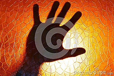 Hand Silhouette on Fire Orange Color Background Stock Photo