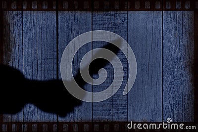 Hand Silhouette with knife on the Natural Wooden Panel Stock Photo