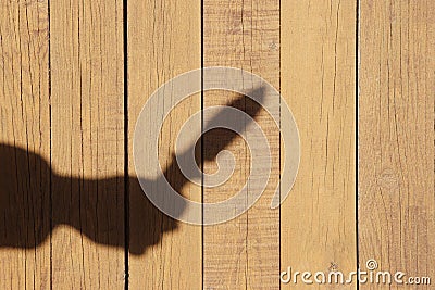 Hand Silhouette with knife on the Natural Wooden Panel Stock Photo