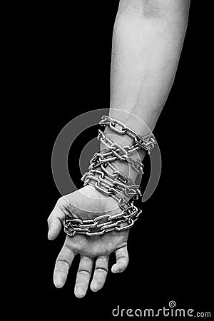 Hand of slave with chains. Hand tied chain Stock Photo