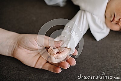 Hand baby in the hand of mother closeup. concept love of family. Stock Photo