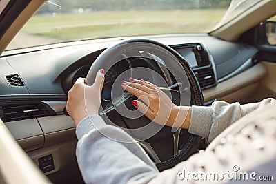 Hand of someone driving car on the road Stock Photo