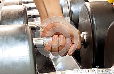 Hand someone holding dumbbell in gym. Stock Photo