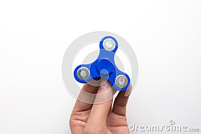 Hand Spiner. Stress relieving toy on white background. Close-up. Top view. Stock photo Stock Photo