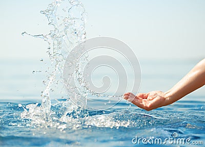 Hand splashing clean water Stock Photo