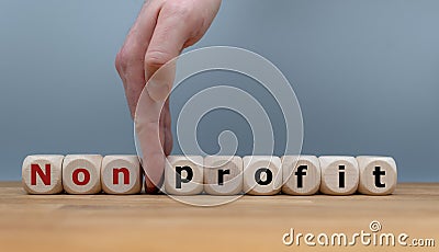 Hand splits the word `nonprofit` to `profiT Stock Photo