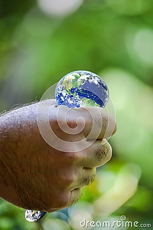 Hand squeezing planet earth Stock Photo