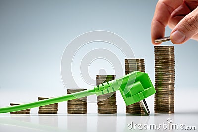 Hand Stacking Coin On Energy Prices Chart Stock Photo