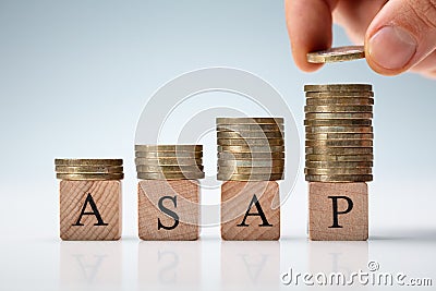 Hand Stacking Coins On Asap Letters Stock Photo